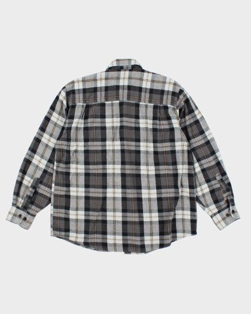 Back view of an oversized black, gray, and white plaid flannel shirt